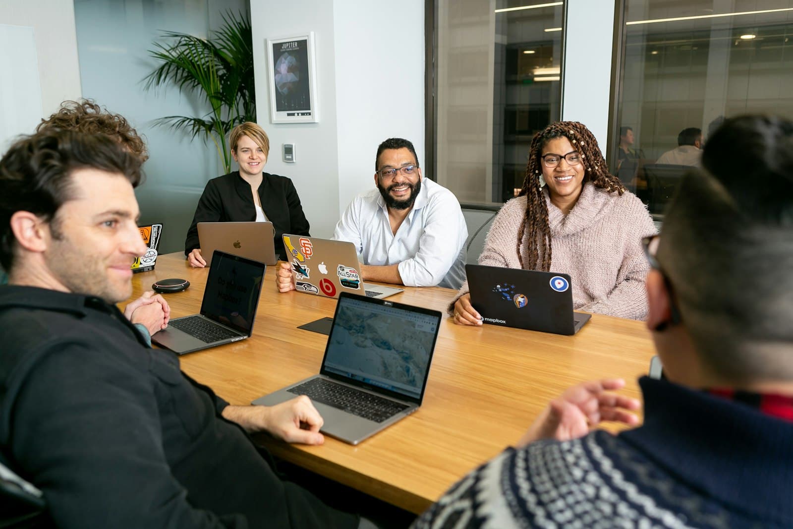 Team collaborating around a laptop