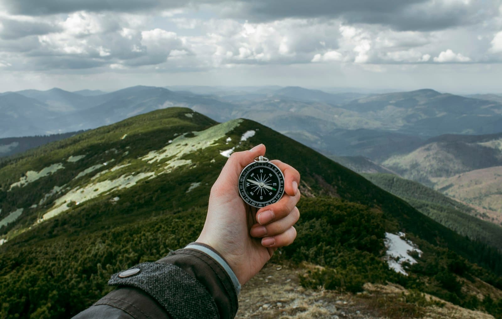 Hand holding a compass — directional choice